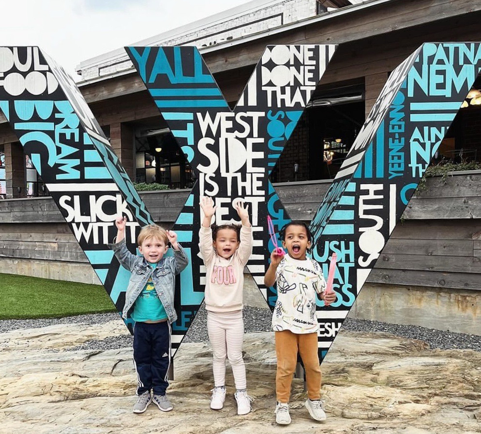 kids in front of W sculpture