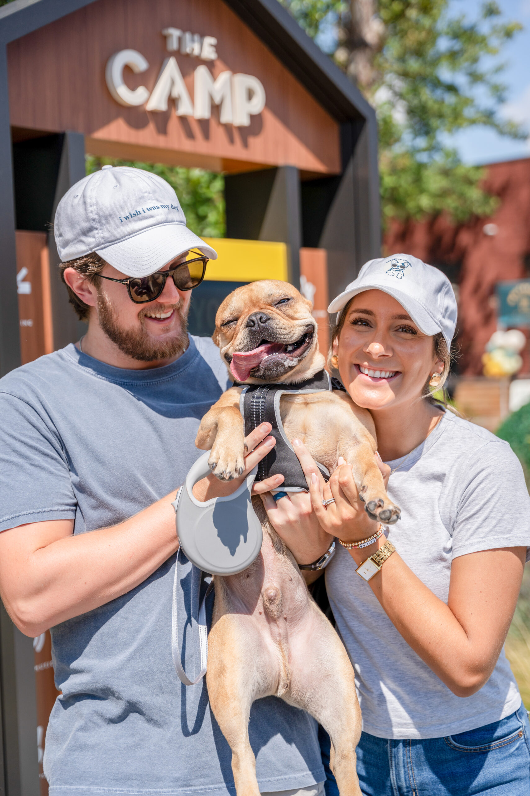 couple holding french bulldog