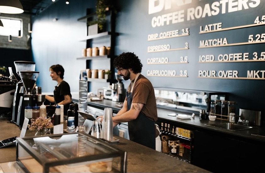 Barista behind a coffee bar